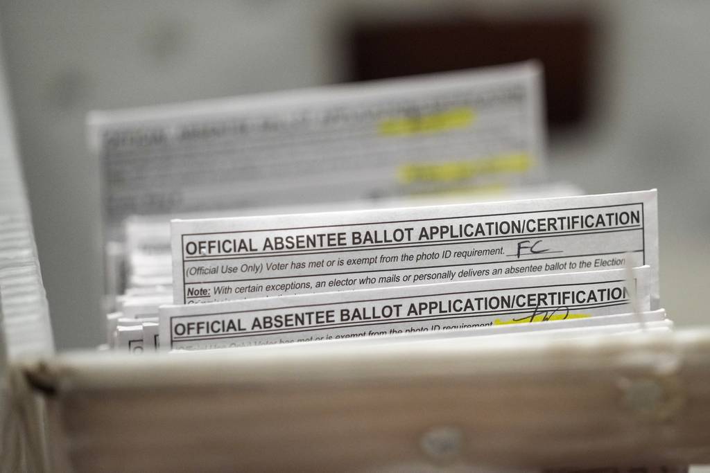 Absentee ballots are seen during a count at the Wisconsin Center for the midterm election on Nov. 8, 2022, in Milwaukee.