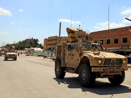Vehicles of the US-led coalition battling the Islamic State group patrol the town of Rmelane in Syria's Hasakeh province on June 5, 2018. (Delil souleiman/AFP via Getty Images)