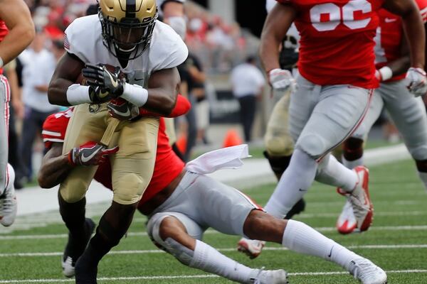 Army running back Kell Walker, left, is tackled by Ohio State safety Damon Webb during the first half of an NCAA college football game Saturday, Sept. 16, 2017, in Columbus, Ohio. (Jay LaPrete/AP)
