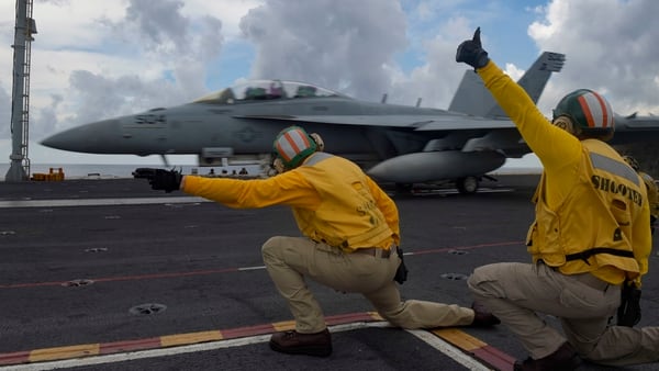 Sailors on Saturday direct an EA-18G Growler from the 