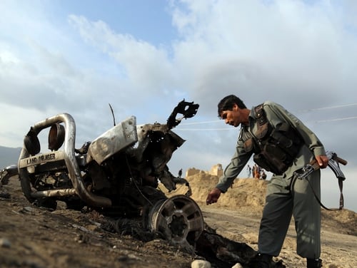 An Afghan security force check the site a day after an an attack near the Bagram Air Base, north of Kabul, Afghanistan, April 9. (Rahmat Gul/AP)