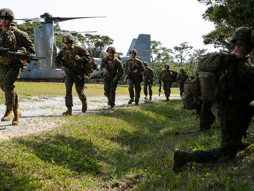 Marines with Charlie Company, Battalion Landing Team, 1st Battalion, 4th Marines, run toward security positions during a live-fire range as part of the 31st Marine Expeditionary Unit's simulated Expeditionary Advanced Base Operations, Camp Schwab, Okinawa, Japan, March 13, 2019. (Gunnery Sgt. T. T. Parish/Marine Corps)