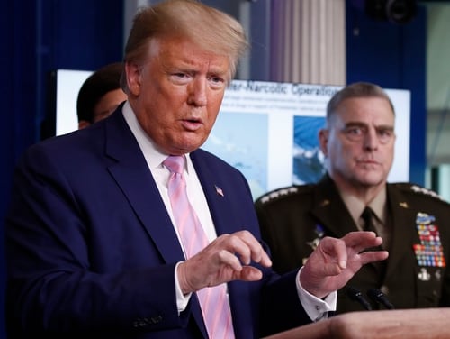 President Donald Trump speaks on April 1 from the White House, as Chairman of the Joint Chiefs Gen. Mark Milley, listens. (Alex Brandon/AP)