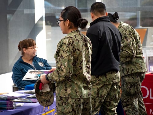 Sailors assigned to Navy Medicine Readiness and Training Command Bremerton in Washington receive information on GI Bill benefits during a college fair on Feb. 20, 2020. (Mass Communication Specialist 3rd Class Haydn N. Smith/Navy)