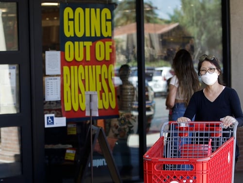 A shopper walks past a Pier 1 Imports store as going out of business signs are posted amid the coronavirus pandemic Wednesday, July 1, 2020, in Santa Clarita, Calif. (AP Photo/Marcio Jose Sanchez)