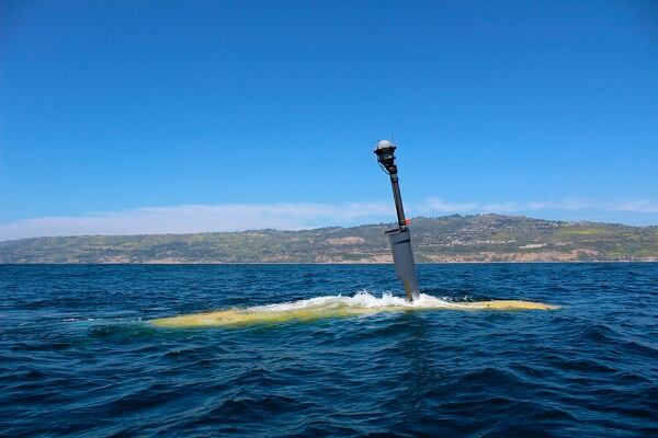 Boeing's Echo Voyager, powered by a hybrid battery/diesel system, moves through the water. A generator kicks in when the battery power ebbs, and the drone raises a mast that provides air to run the diesel engines, which recharge the batteries. (Boeing vie AP)