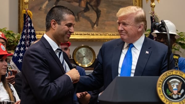 Former U.S. President Donald Trump shakes hands with his Federal Communications Commission (FCC) chairman Ajit Pai (L) during an announcement about 5G network deployment in the Roosevelt Room at the White House in Washington, DC, on April 12, 2019. (NICHOLAS KAMM/AFP via Getty Images)