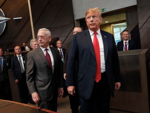 President Donald Trump, right, walks with Defense Secretary Jim Mattis, left, at the multilateral meeting of the North Atlantic Council on July 11, 2018, in Belgium. A new report suggests growing tensions between the two leaders. (Pablo Martinez Monsivais/AP)