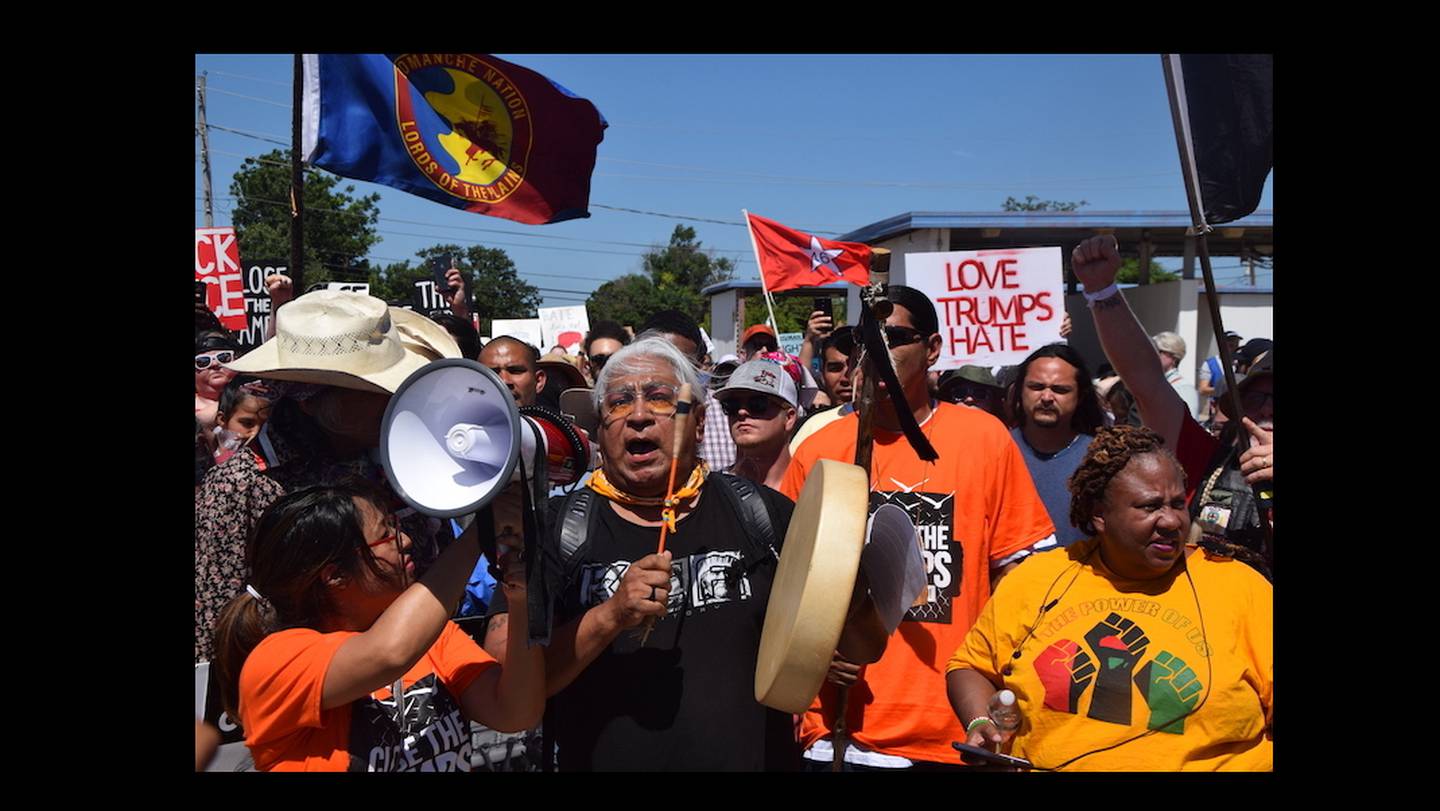 Dr. Cornel Pewewardy beats the drum and leads  protesters as they march along Northwest Ozmun Avenue and onto Sheridan Road to the Fort Sill entry gates, Saturday, July 20, 2019 in Lawton, Okla