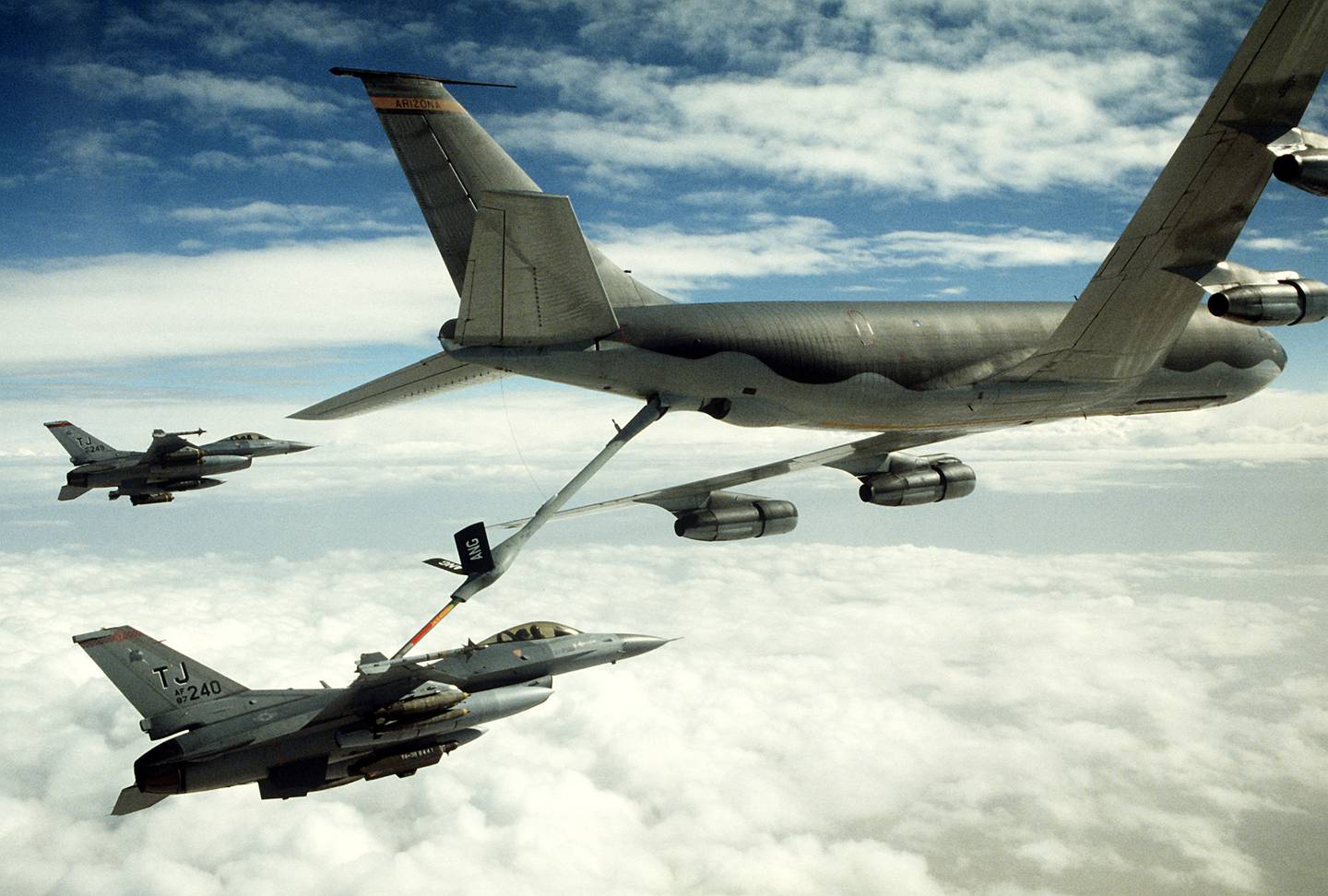 A 401st Tactical Fighter Wing F-16C Fighting Falcon aircraft refuels from a KC-135 Stratotanker aircraft as another F-16 stands by during Operation Desert Storm on Feb. 1, 1991.