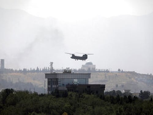 A U.S. Chinook helicopter flies over the U.S. Embassy in Kabul, Afghanistan, Sunday, Aug. 15, 2021. (Rahmat Gul/AP)