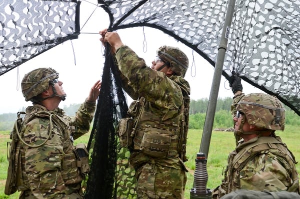 The Field Artillery Squadron radar section of 2nd Cavalry Regiment, at Vilseck, Germany, conceals their area of operation with a camouflage net in Estonia at Saber Strike 16. (Staff Sgt. Steven M. Colvin/Army)