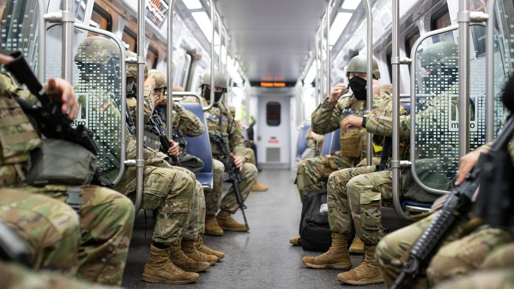 Soldiers with the North Carolina National Guard ride a Metro train that will get them to the station they will guard for the 59th Presidential Inauguration in Washington on Jan. 20, 2021.