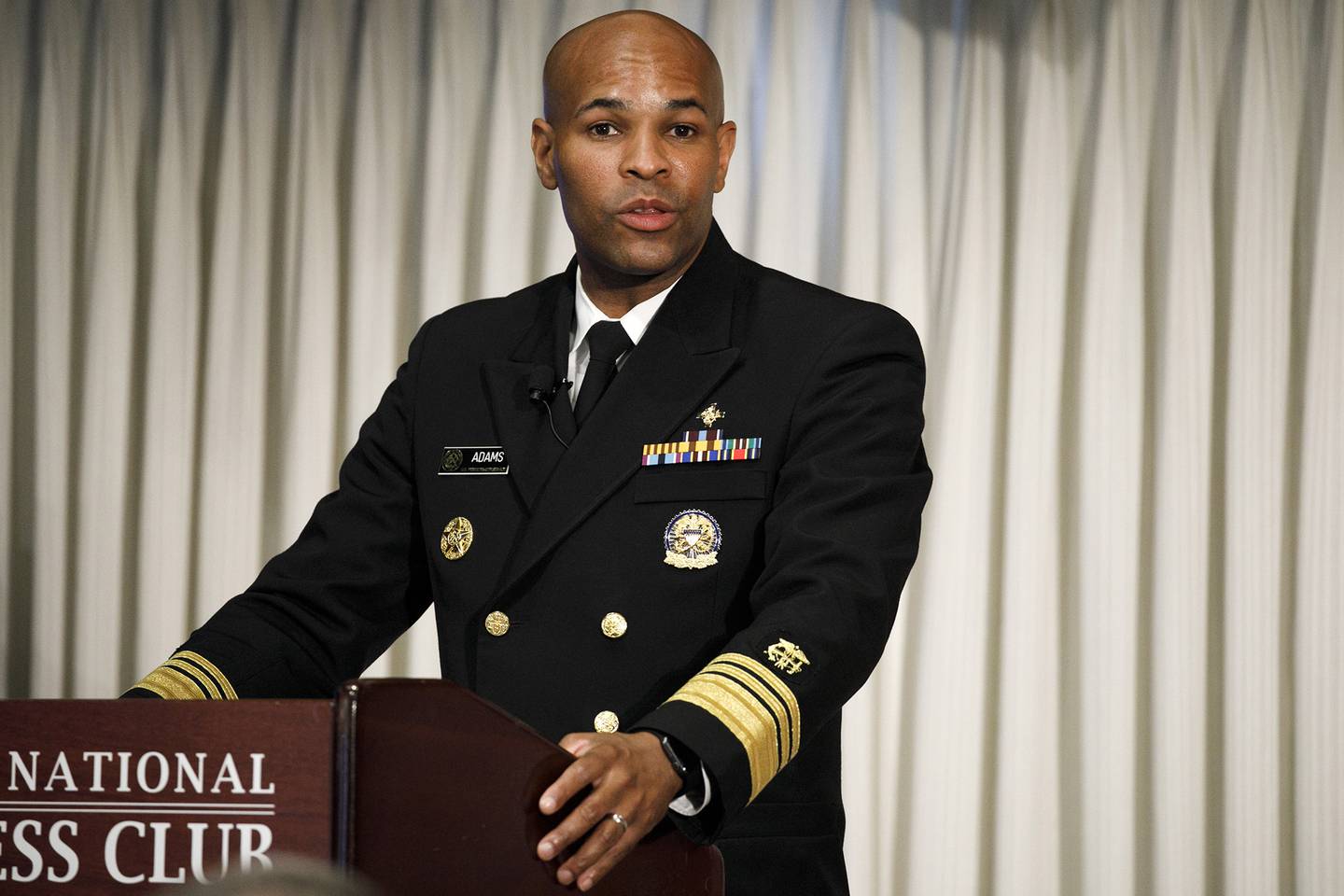 Surgeon General Jerome Adams speaks at the National Press Club about a campaign to raise awareness on the risks of veterans suicide, Tuesday, July 7, 2020, in Washington.