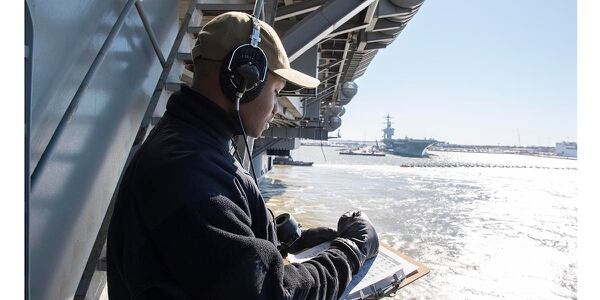 Yeoman Seaman Jordan Wright mans a sound powered phone in deck control aboard the aircraft carrier Harry S. Truman as it returned to Naval Station Norfolk following a week-long underway to increase crew proficiency before its sustainment exercise. (Mass Communication Specialist 3rd Class Sam Jenkins/Navy)