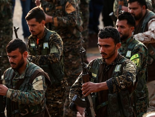 Syrian Kurdish members of the People's Protection Units (YPG) attend the funeral of a slain Kurdish commander in the northeastern city of Qamishli on Dec. 6, 2018. (Delil Souleiman/AFP via Getty images)