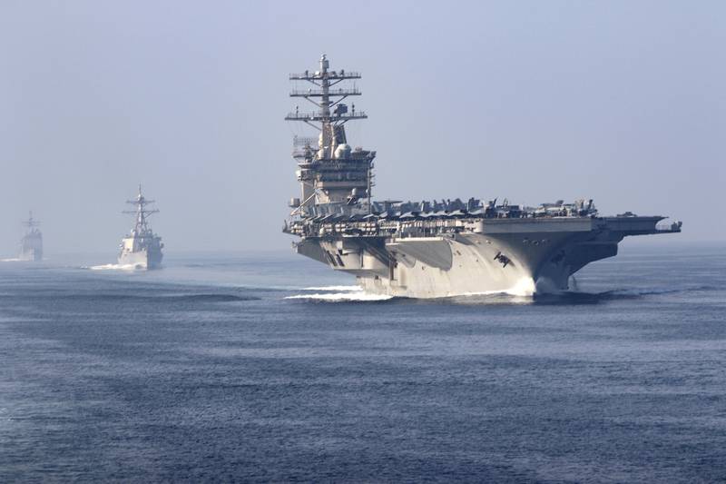The aircraft carrier USS Nimitz (CVN 68), guided-missile destroyer USS John Paul Jones (DDG 53), center, and the guided-missile cruiser USS Princeton (CG 59) sail in formation during a scheduled transit of the Strait of Hormuz, Nov. 9, 2020.