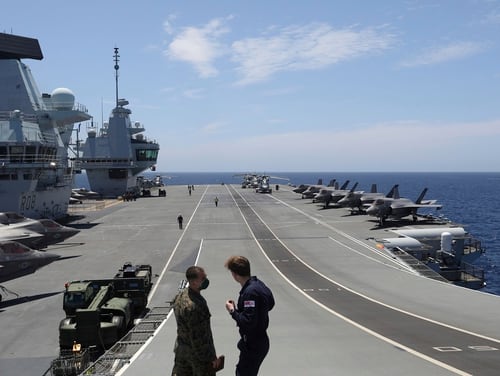 Military personnel participate in the NATO Steadfast Defender 2021 exercise on the deck of the aircraft carrier HMS Queen Elizabeth off the coast of Portugal on May 27, 2021. (Ana Brigida/AP)
