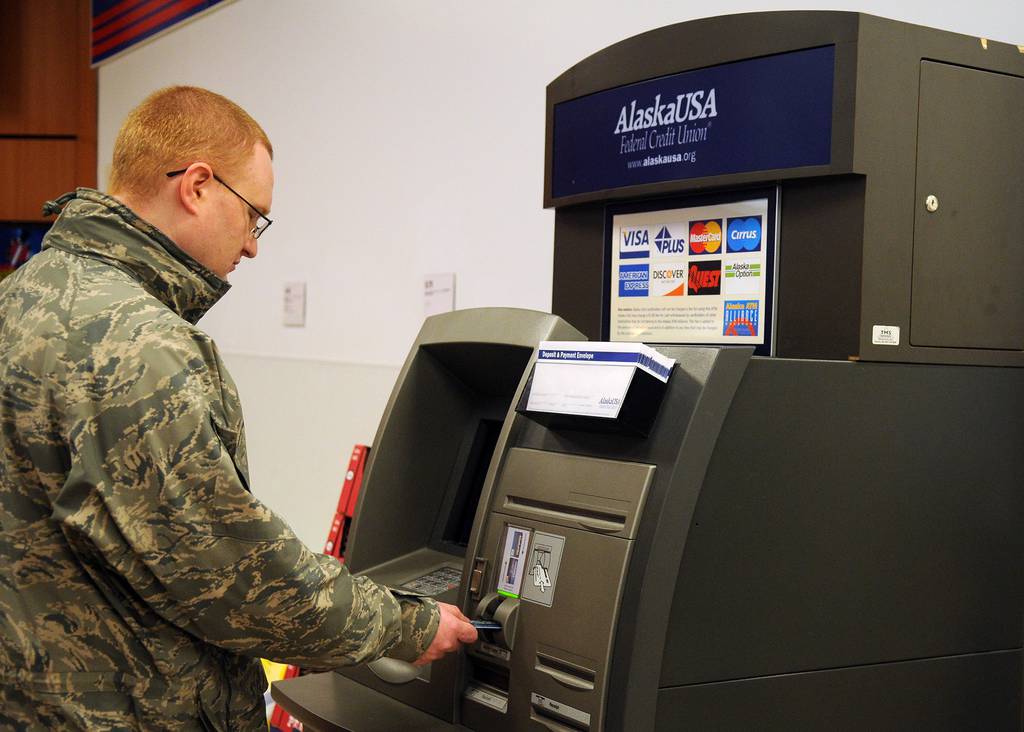 An airman inserts a bank card into an ATM Oct. 26, 2010, at Eielson Air Force Base, Alaska.