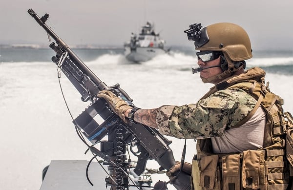 Chief Quarter Master Jaime Villalobos, from Los Angeles, California, mans a M240B machine gun aboard a MKVI patrol boat. (U.S. Navy photo by BMC Nelson Doromal Jr)