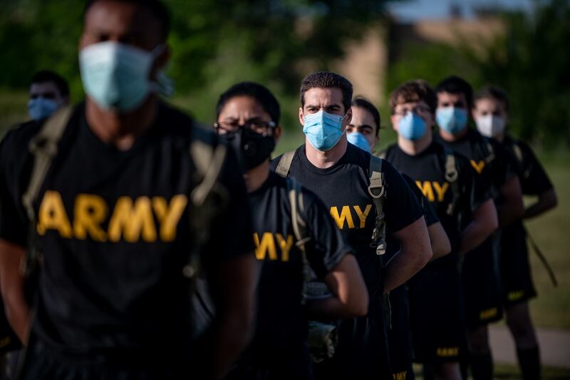Soldiers at Fort Sill, in Oklahoma, stand in formation while wearing masks and maintaining physical distancing during reception before entering basic combat training May 14, 2020. (Sgt. Dustin D. Biven/Army)