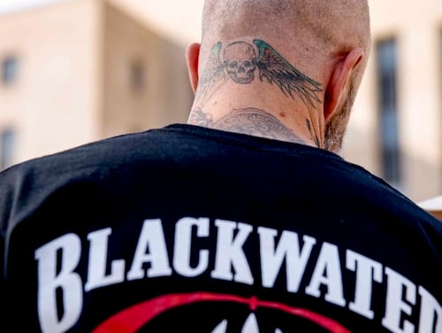 A former member of Blackwater joins family members, friends, and supporters of four former Blackwater security guards outside the federal court in Washington on April 13, 2015, following sentencing for four former Blackwater security guards in connection with a 2007 shooting of civilians in Iraq. (Andrew Harnik/AP)
