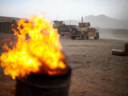 Wind fans the flames of a burn pit at Combat Outpost Tangi in the Tangi Valley of Afghanistan on Aug. 31, 2009. (Staff Sgt. Teddy Wade/Army)