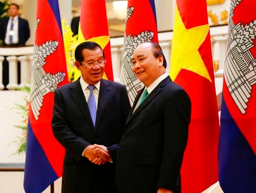 Cambodian Prime Minister Hun Sen, left, shakes hands with his Vietnamese counterpart Nguyen Xuan Phuc before heading for talks behind closed doors in Hanoi on Friday. Hun Sen is on a three-day visit to boost ties between the two neighboring countries. (Tran Van Minh/AP)