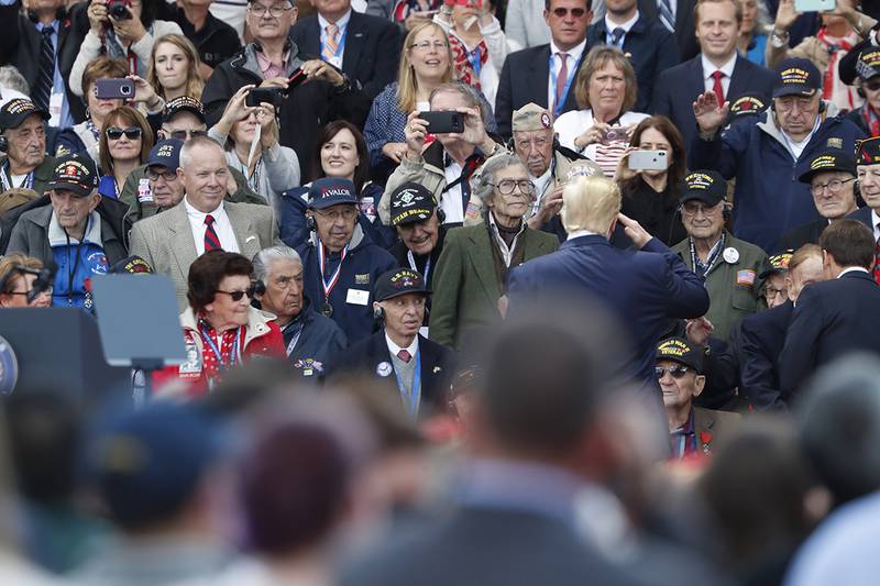 U.S. President Donald Trump salutes to veterans prior to a ceremony to mark the 75th anniversary of D-Day at the Normandy American Cemetery
