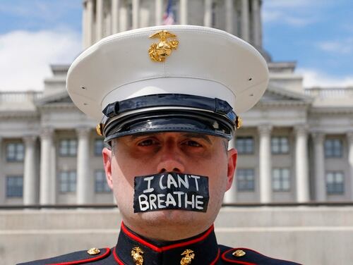 Marine veteran Todd Winn, wearing a mask which reads 