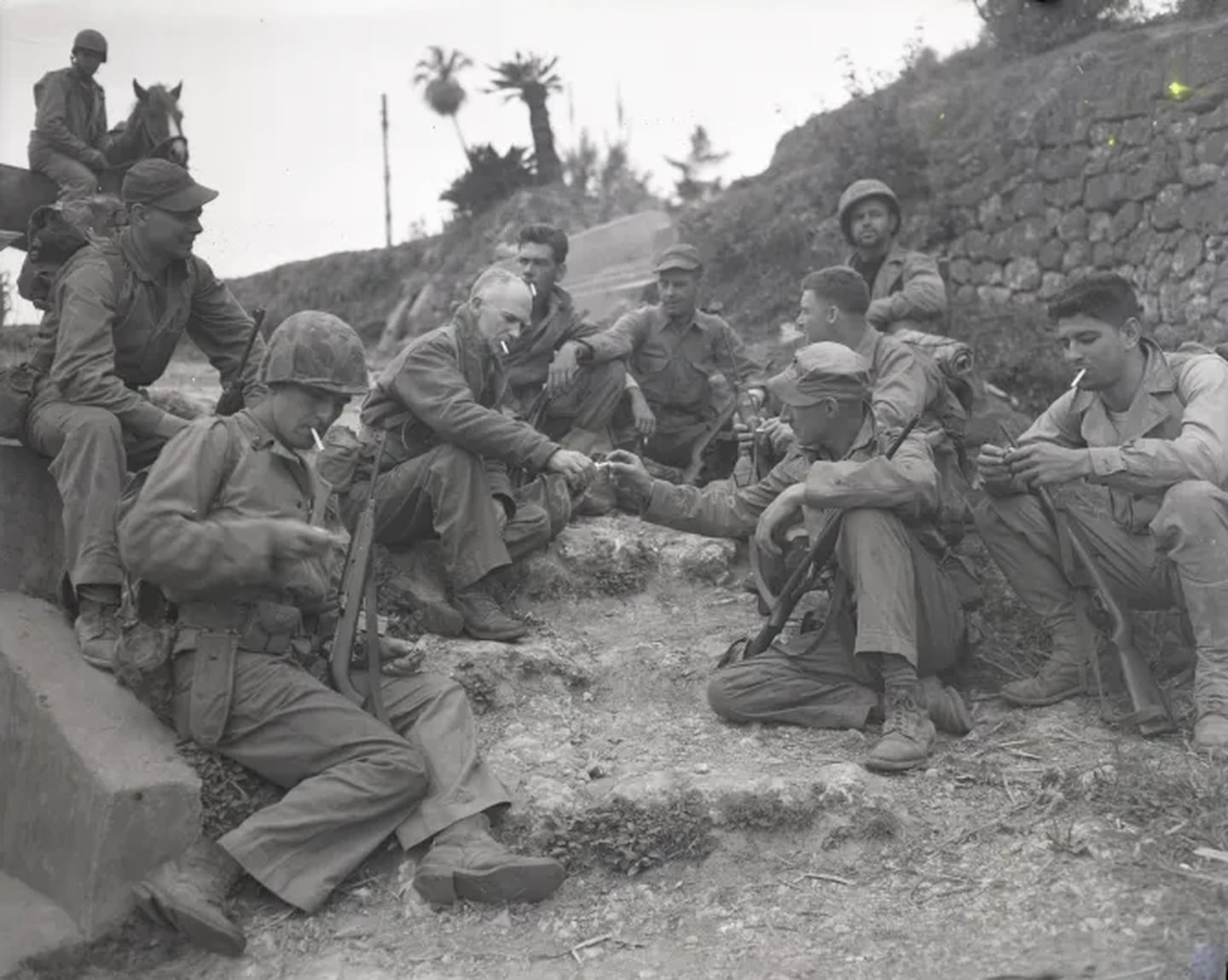 Columnist Ernie Pyle rests on the roadside with a Marine patrol on April 8, 1945.