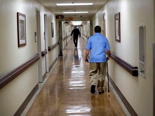 A patient walks down a hallway at the Fayetteville Veterans Affairs Medical Center in North Carolina in March 2015. Critics and supporters of plans to expand veterans access to private-sector medical appointments are gearing up for a new round of fights after the release of new draft community care rules this week. (Patrick Semansky/AP)