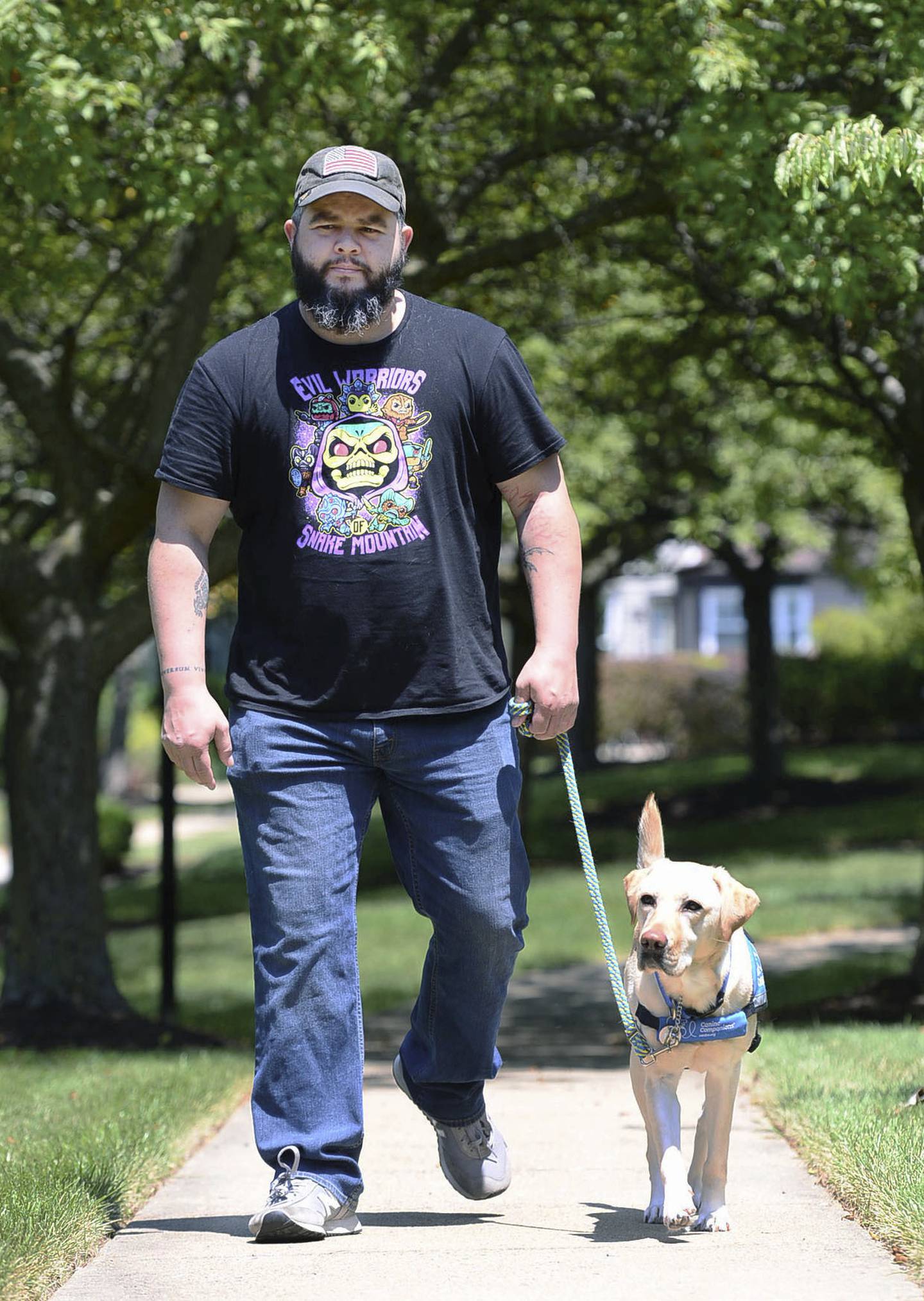 Joe Nieves walks with his service dog Jem near his home in Frederick, Md.