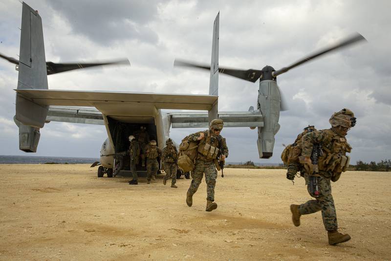 U.S. Marines run out of an MV-22B Osprey tiltrotor aircraft on Jan. 28, 2021, during an exercise on Ie Shima, Okinawa, Japan. (