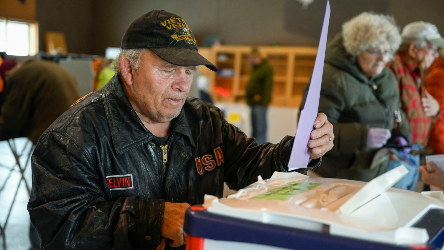 Melvin L Quakenbush drops his ballot in the box after voting at the Pablo Christian Church on the Flathead Indian Reservation in Pablo, Mont., Tuesday, Nov. 8, 2022. (AP Photo/Tomy Martino)