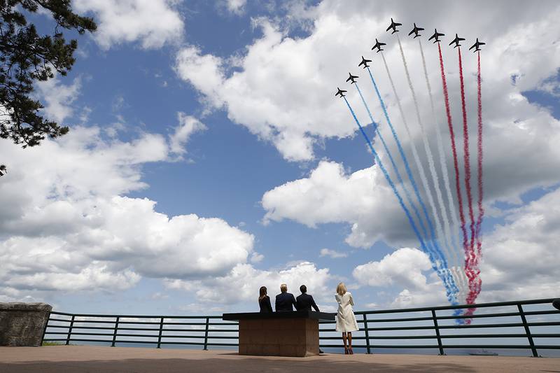 President Donald Trump, first lady Melania Trump, French President Emmanuel Macron and Brigitte Macron, watch a flyover during a ceremony to commemorate the 75th anniversary of D-Day at the American Normandy cemetery
