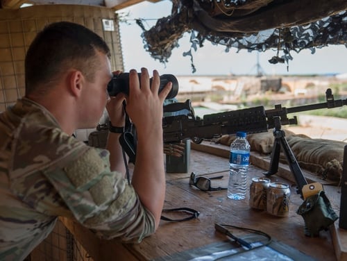 U.S. Army Private Dylan Yarbro, infantryman, assigned to Task Force Guardian, 41st Infantry Brigade Combat Team (IBCT), 1-186th Infantry Battalion, Oregon National Guard, uses binoculars to scan the horizon while on security watch in Somalia, on December 3, 2019. (Tech. Sgt. Nick Kibbey/ Air Force)