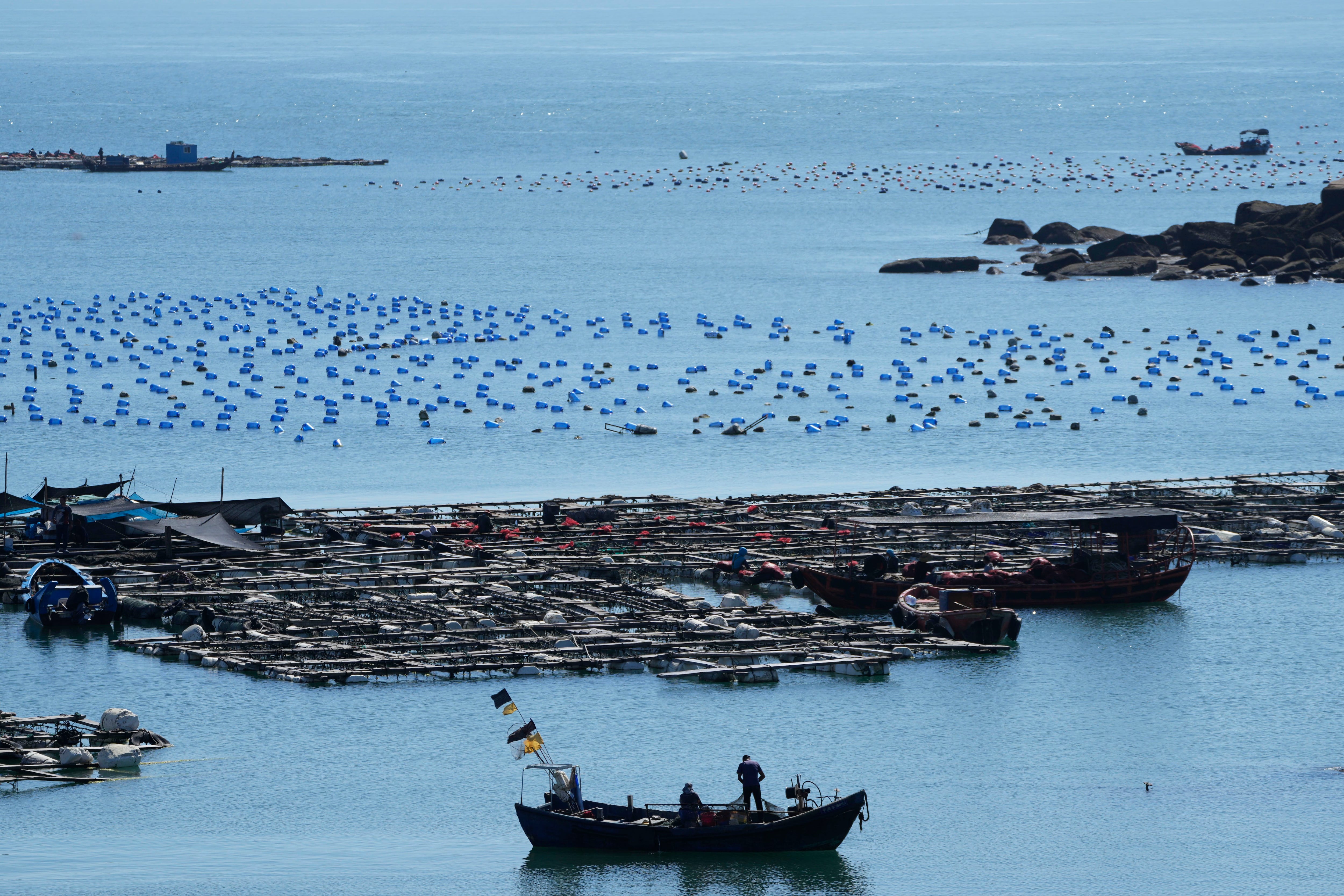 A boat moves through the water at the 68-nautical-mile scenic spot, the closest point in mainland China to the island of Taiwan, in Pingtan in southeastern China's Fujian Province, Friday, Aug. 5, 2022. (AP Photo/Ng Han Guan)