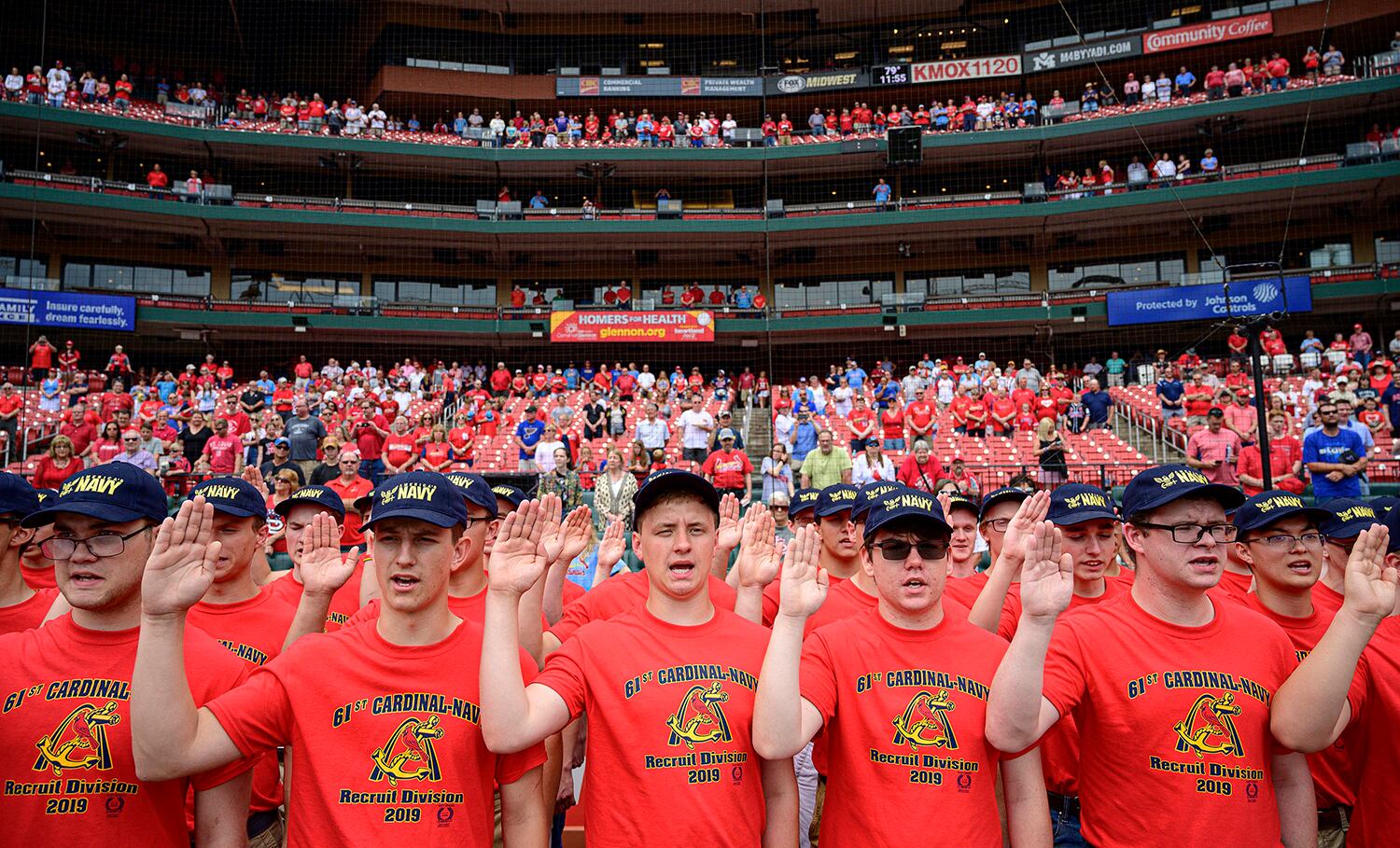Eighty-one recruits with the 61st Annual Recruit Cardinal Division recite the oath of enlistment at Busch Stadium during a pre-game ceremony, June 6, 2019, in St. Louis.