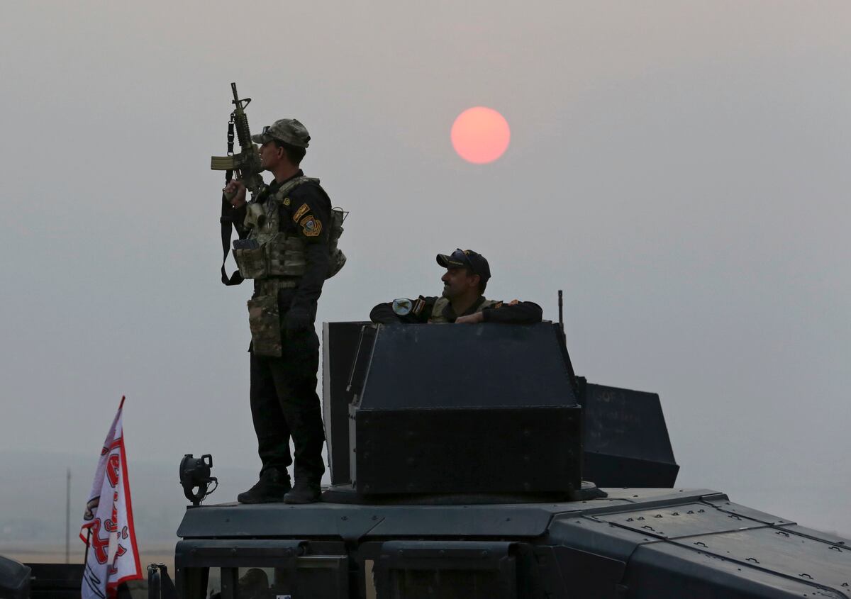 U.S.-backed Iraqi forces battle ISIS in western town, far from Mosul