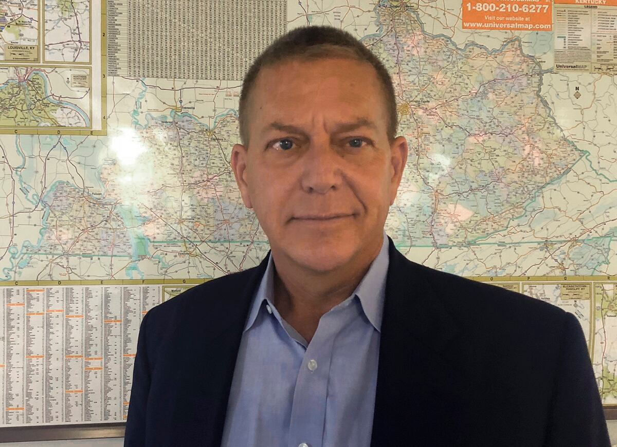 This July 15, 2019, photo shows Democrat Mike Broihier, a Marine veteran, standing in front of the map of Kentucky at the Associated Press bureau in Louisville, Ky.