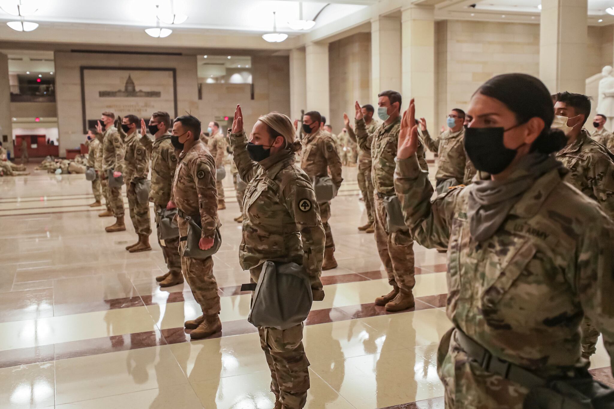 U.S. soldiers with the New Jersey National Guard take the oath of office to serve with Capitol Police in the Visitor Center at the U.S. Capitol in Washington on Jan. 13, 2021.