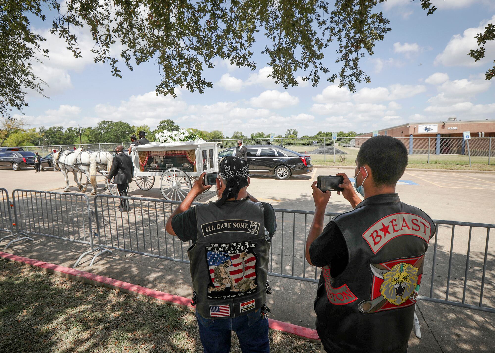 A horse-drawn carriage with the remains of U.S. Army Spc. Vanessa Guillen exits after making a final lap around the Cesar Chavez High School track Friday, Aug. 14, 2020, in Houston.