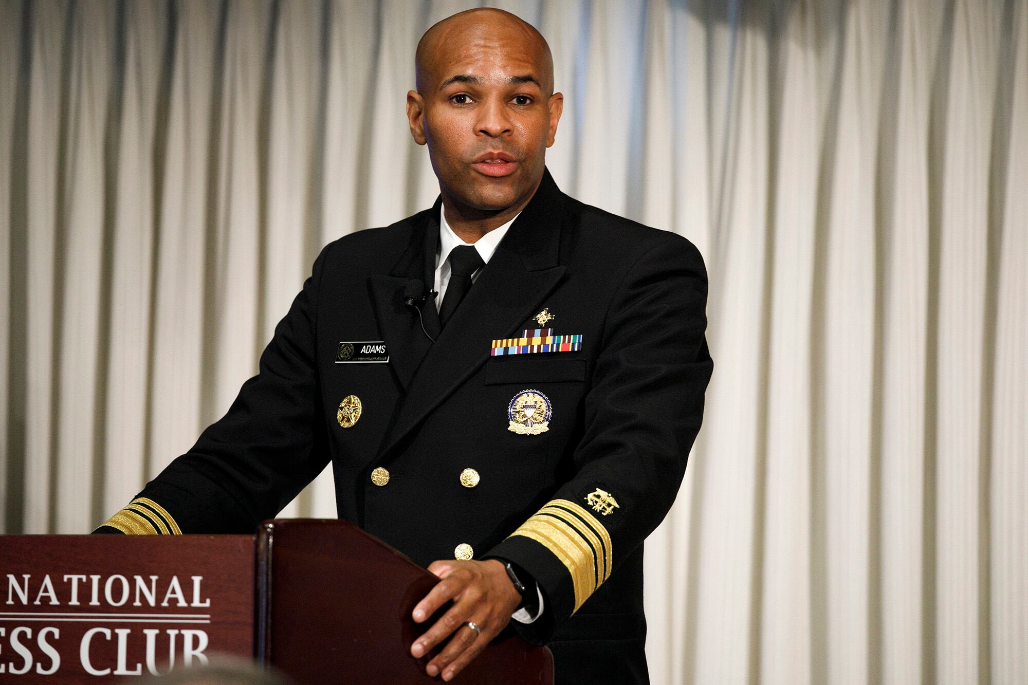 Surgeon General Jerome Adams speaks at the National Press Club about a campaign to raise awareness on the risks of veterans suicide, Tuesday, July 7, 2020, in Washington.