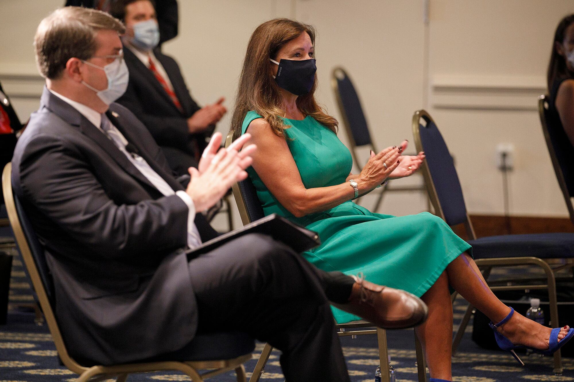 Secretary of Veterans Affairs Richard Wilkie, left, and second lady Karen Pence, wearing protective masks against COVID-19, applaud as they attend an event on a campaign to raise awareness on the risks of veterans suicide on July 7, 2020, at the National Press Club in Washington.