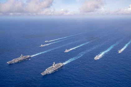 The Theodore Roosevelt and Nimitz carrier strike groups transit the Philippine Sea in formation while conducting dual carrier and airwing operations on June 23, 2020.