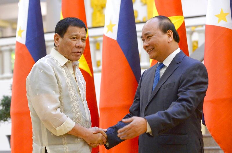 In this Sept. 29, 2016 photo, Philippine President Rodrigo Duterte, left, shakes hands with Vietnamese Prime Minister Nguyen Xuan Phuc as they meet at the Cabinet Office in Hanoi, Vietnam. President Duterte and Prime Minister Nguyen Xuan Phuc have discussed delineating their countries’ maritime boundaries in the South China Sea, in what Beijing will likely perceive as another challenge to its claim to virtually the entire strategic waterway. Duterte said Friday, without elaborating, that he told Prime Minister Nguyen Xuan Phuc in a meeting in Indonesia that such boundary talks may take longer because the Philippines is still establishing its continental shelf limit - the country's outermost boundary. (Hoang Dinh Nam/AP)