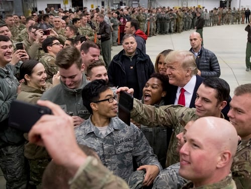 In this Dec. 27, 2018, file photo, President Donald Trump, center right, and first lady Melania Trump, center left, greet members of the military at Ramstein Air Base, Germany. (Andrew Harnik/AP)