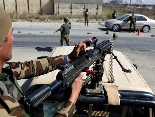 Afghan National Army soldiers search a car in October at the Independent Election Commission compound in Kabul, Afghanistan. Although enemy attacks have decreased recently, the UN assistance mission reports suicide attacks have gone up nearly 40 percent compared to the same period in 2017. (Rahmat Gul/AP)