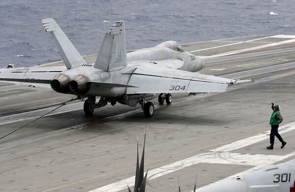 A U.S. fighter jet lands on the U.S. aircraft carrier USS Ronald Reagan following their patrol at the international waters off South China Sea Tuesday, Aug. 6, 2019. (Bullit Marquez/AP)